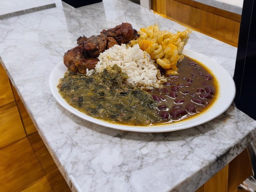Sarrah's Sunday lunch plate with rice greens red beans macaroni pie and meat